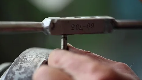 Worker threading with hand tap Stock Footage 70208230