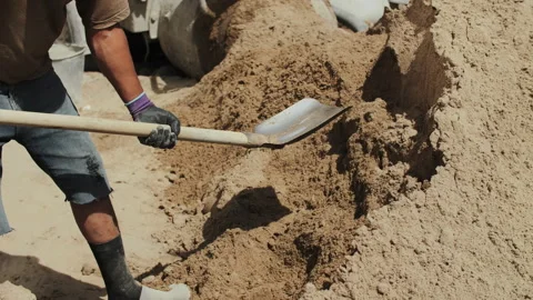 Worker throwing construction sand with a shovel Stock Footage 288008125