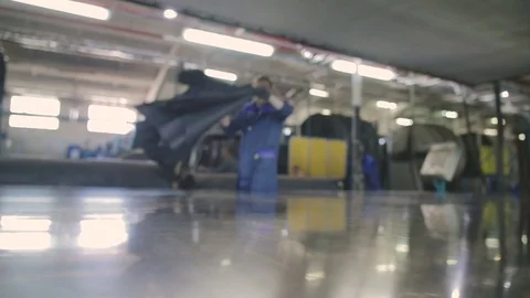 Worker throws a piece of leather over the surface of a large hydraulic dryer Video stock 79483164