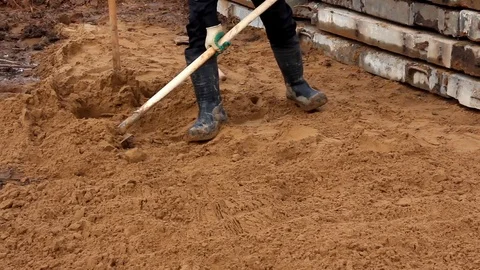 Worker throws sand with a shovel Stock Footage 126340984