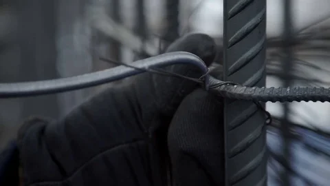 Worker ties the armature with wire Stock Footage 82137634