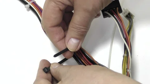 The worker ties the wires with a plastic tie. Stock-Footage 118775816