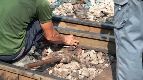 The worker tightened the screws on the rail with a large wrench in hand. Stock Footage 171753795