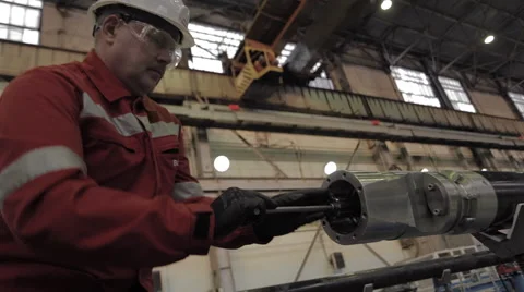 Worker tightening the bolt in the pipe for the pump Stock Footage 62085974