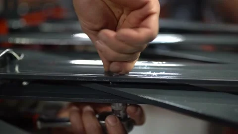 Worker Tightening The Screws With Tool - 4k 100 fps - Stock Footage 196149882