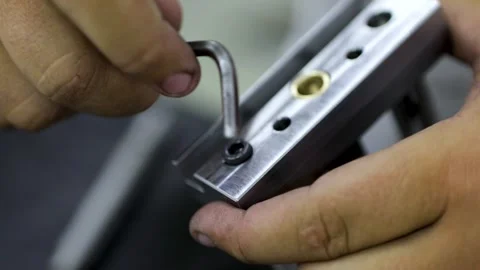 Worker tightening the screws with tool Stock Footage 133439428