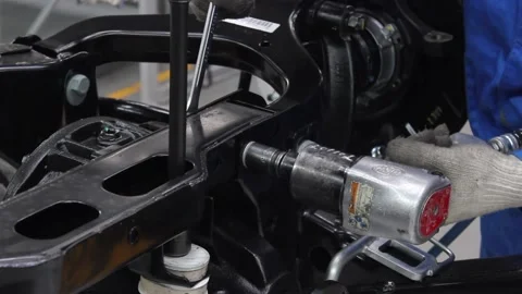 Worker tightens the bolt on the conveyor. Stock Footage 122335797