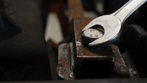 A worker tightens a large bolt with a large wrench Stock Footage 163929391