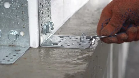 The worker tightens the nut with a wrench Stock Footage 218471558