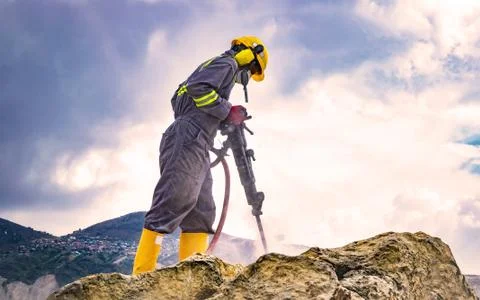 Worker on top of a rock Stock Photos