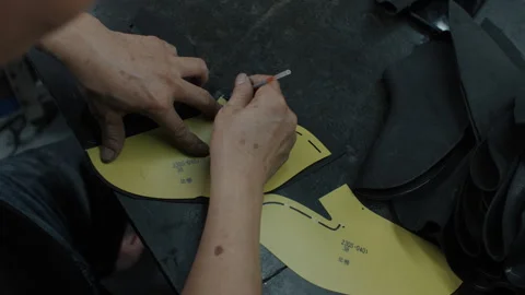 Worker Tracing Shoe Pattern Templates on Leather in Footwear Manufacturing Stock Footage 341669040