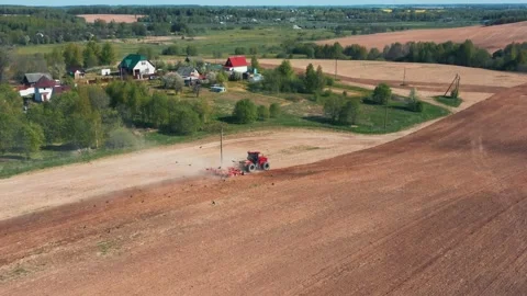 Worker Tractor With Plow Trailer Plowing Ground On Agricultural Field Stock Footage 265102641
