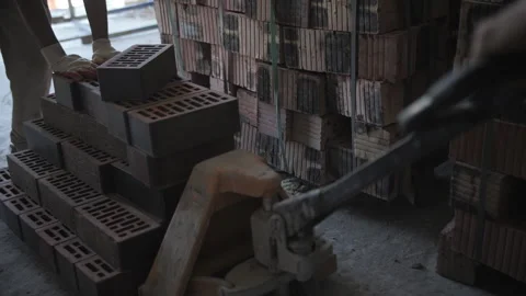 Worker transporting bricks on a trolley Stock Footage 285540977