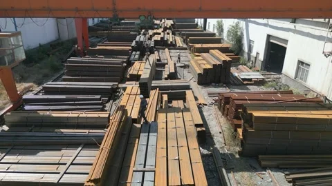 Worker transporting stack of metal pipes with gantry crane Stock Footage 249096038