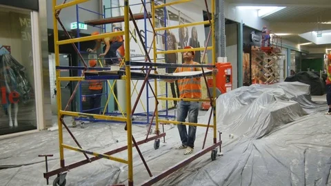 Worker Transports Carefully Building Ladder in Shopping Mall Stock Footage 80433286