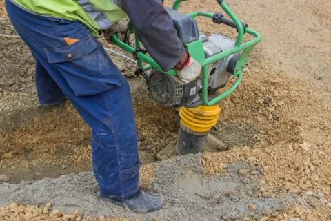 Worker with trench rammer Stock Photos