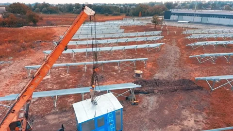 Worker trying to attach the hooks from crane to the metal booth. Stock Footage 195931440