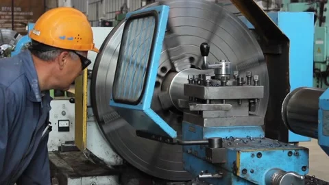 Worker turner, does his job on an old lathe and controls metal processing. Stock Footage 124576538