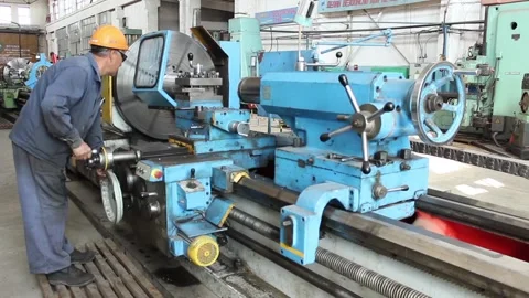 Worker turner, does his job on an old lathe and controls metal processing. Video stock 124576542