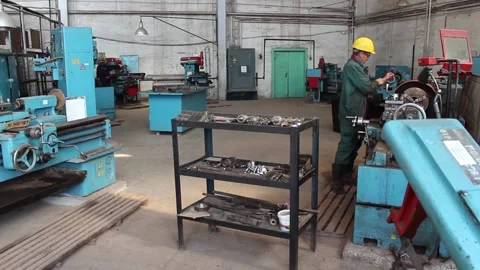 Worker-turner is preparing to work on a lathe. Stock Footage 124576611