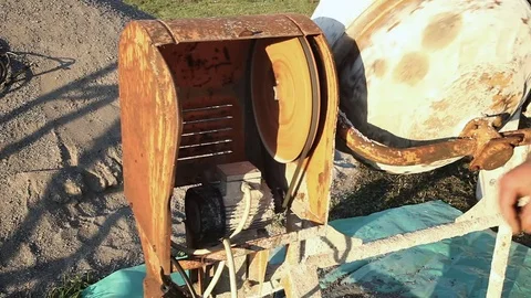Worker is turning on the cement mixer Stock Footage 75773168