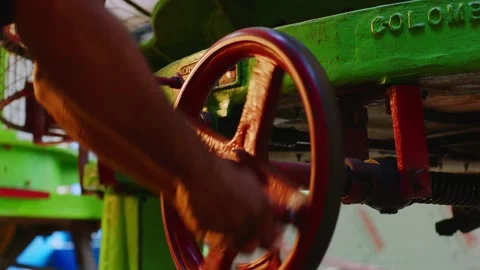 Worker turning valve wheel on green industrial machine, close up Video stock 327573600