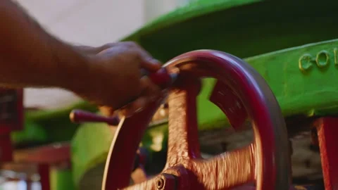 Worker Turning Valve Wheel on Industrial Machine, Close Up Stock Footage 335827588