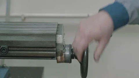 Worker turning the wheel of a lathe. Stock Footage 148387181
