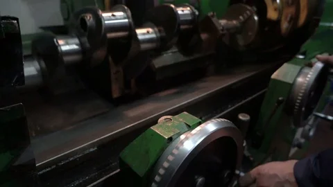 Worker turns the handle of the cnc machine. Crankshaft grinding. Repair work on Stock Footage 75237797