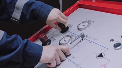 A worker turns on a pressure sensor at the factory. Hands are large. Stock Footage 319546436