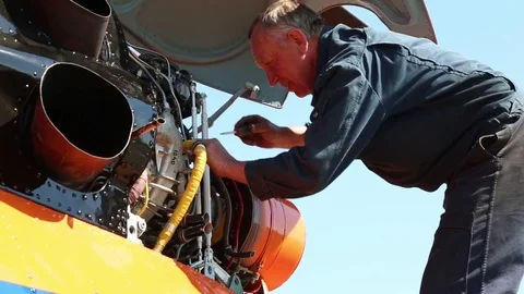 The worker turns the screwdriver in the motor. Stock Footage 81530810