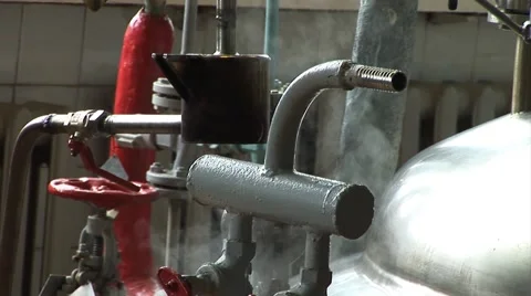 Worker turns the valve in the pipe. Pipes and valves in manufacturing Video stock 50523555