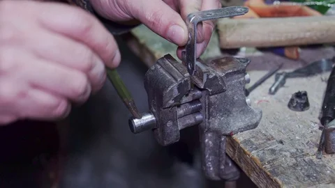 The worker twists a metal corner in a vice closeup Stock Footage 102177083