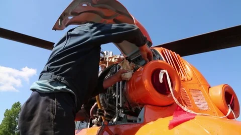 The worker twists the nuts in the engine. Stock Footage 81530859