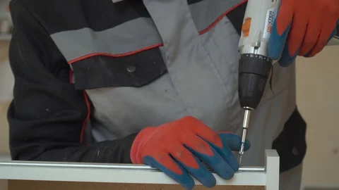Worker twists the screw with a drill Stock Footage 89546448