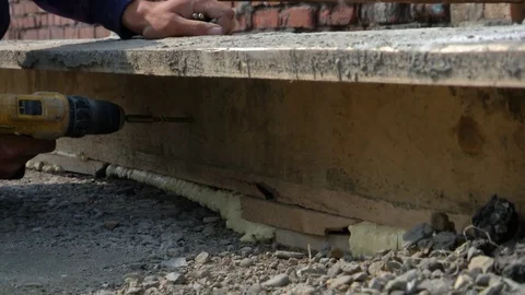 Worker twists a screw with a drill Stock Footage 115331342