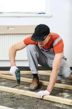 Worker twists the screw. Stock Photos