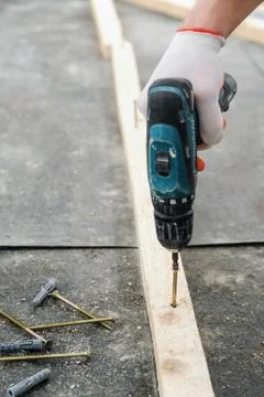 Worker twists the screw. Stock Photos