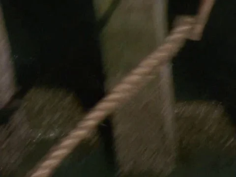 Worker tying a rope to pole in harbor Video stock 79877877