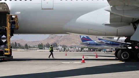Worker under airplane Stock Footage