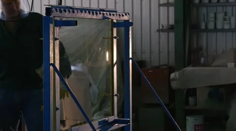 Worker in Uniform and Protective Screen Approaches And Beats The Glass in The Stock Footage 53011648