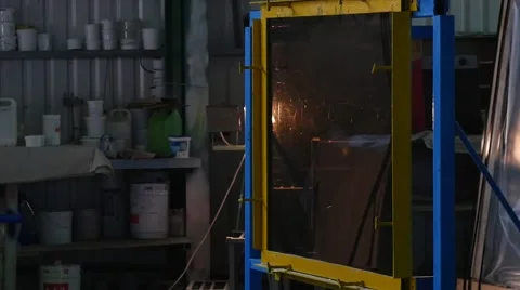 Worker in Uniform And Protective Screen is Beating the Smooth Sheet of Glass Stock Footage 53011865