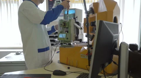 Worker in uniform checking quality of theodolite Stock Footage 65014022