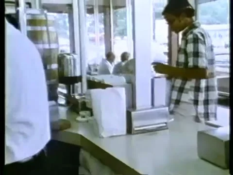 Worker in uniform packing burgers in restaurant Stock Footage 260258081