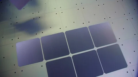 Worker in uniform puts cell onto solar panel in workshop Stock Footage 122905563