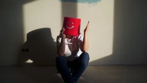 Worker in uniform with red bucket on his head have fun Stock Footage 104582721