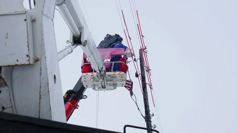 Worker in uniform repairs power lines in truck crane basket Stock Footage 126666121