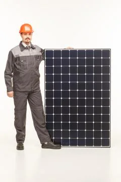 Worker in uniform with solar panels Stock Photos
