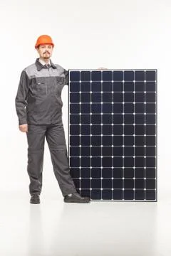 Worker in uniform with solar panels Stock Photos