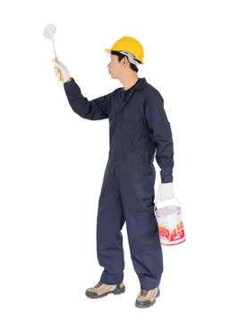 Worker in a uniform using a paint roller is painting invisible wall Stock Photos